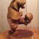 Wood sculptor bear with a soccer ball